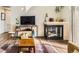 Inviting living space featuring fireplace, wood floors, and media center at 8165 E Lowry Blvd # 310, Denver, CO 80230