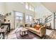 Bright living room with fireplace, large windows, and staircase at 8165 E Lowry Blvd # 310, Denver, CO 80230