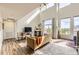 Open-concept living room boasts vaulted ceilings and a cozy fireplace at 8165 E Lowry Blvd # 310, Denver, CO 80230