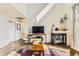 Comfortable living room with fireplace, wood floors, and natural light at 8165 E Lowry Blvd # 310, Denver, CO 80230