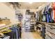 Well-organized walk-in closet with multiple shelves, hanging rods, and storage solutions at 8165 E Lowry Blvd # 310, Denver, CO 80230