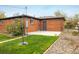 Back exterior of brick home featuring a small concrete patio area at 740 Lotus Way, Broomfield, CO 80020