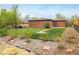 Landscaped backyard with healthy green lawn and garden beds at 740 Lotus Way, Broomfield, CO 80020