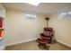 Finished basement sitting area with chair, ottoman and built-in bookshelves at 740 Lotus Way, Broomfield, CO 80020