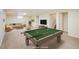 Spacious basement with a pool table, TV, and comfortable sitting area at 740 Lotus Way, Broomfield, CO 80020