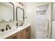 Modern bathroom with double sink vanity, stylish mirrors, and walk-in shower at 740 Lotus Way, Broomfield, CO 80020