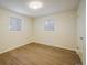 Bright bedroom with two windows, hardwood floors, and neutral paint, creating a spacious and airy retreat at 740 Lotus Way, Broomfield, CO 80020