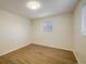 Comfortable bedroom featuring hardwood floors and a large window at 740 Lotus Way, Broomfield, CO 80020