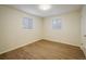 Bright bedroom with hardwood flooring and two windows at 740 Lotus Way, Broomfield, CO 80020