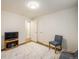 Bright bedroom with carpet flooring, a tv on a wooden console, and neutral walls at 740 Lotus Way, Broomfield, CO 80020