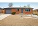 Charming brick ranch-style home with a well-maintained gravel front yard and gray trim at 740 Lotus Way, Broomfield, CO 80020