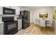 Modern kitchen with black appliances, white cabinets, and a dining area creating a seamless flow for cooking and dining at 740 Lotus Way, Broomfield, CO 80020