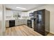 Contemporary kitchen featuring black appliances, updated cabinets, and ample counter space, great for cooking at 740 Lotus Way, Broomfield, CO 80020