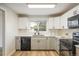 Well-equipped kitchen boasting updated cabinets, modern appliances, and stylish backsplash enhancing its functionality at 740 Lotus Way, Broomfield, CO 80020