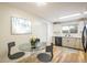 Bright eat-in kitchen features a glass table and stainless appliances at 740 Lotus Way, Broomfield, CO 80020