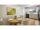Charming dining area adjacent to the modern kitchen featuring wood floors and neutral paint creating a warm atmosphere at 740 Lotus Way, Broomfield, CO 80020
