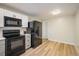 Well-equipped kitchen with black appliances and sleek countertops at 740 Lotus Way, Broomfield, CO 80020