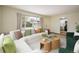 Inviting living room with a large window, stylish furniture, and a peek into the kitchen at 740 Lotus Way, Broomfield, CO 80020