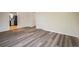 Open-concept living area with wood-look floors leads to kitchen at 740 Lotus Way, Broomfield, CO 80020