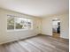 Bright, open living room with hardwood floors and a large window overlooking the front yard at 740 Lotus Way, Broomfield, CO 80020