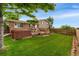 Spacious backyard featuring a well-manicured lawn, wooden deck, and inviting hot tub for relaxation and entertainment at 6798 Depew St, Arvada, CO 80003
