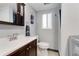 Bathroom with a white sink, wood cabinets and modern fixtures at 6798 Depew St, Arvada, CO 80003