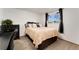 Bedroom with a large window with dark curtains at 6798 Depew St, Arvada, CO 80003