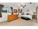 Bedroom featuring two windows, neutral carpet and a ceiling fan at 6798 Depew St, Arvada, CO 80003