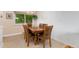Cozy dining room featuring a wood table with seating for six, natural light, and a neutral color scheme at 6798 Depew St, Arvada, CO 80003