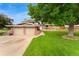 Charming two-story home with a brick facade, attached two-car garage, and a lush green lawn at 6798 Depew St, Arvada, CO 80003