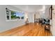 Bright and airy living room featuring hardwood floors, a bay window, and an open floor plan for easy entertaining at 6798 Depew St, Arvada, CO 80003