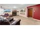 Cozy living room features a fireplace and a large television for entertainment at 6798 Depew St, Arvada, CO 80003
