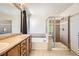 Bright bathroom features a soaking tub, glass shower enclosure, and dual-sink vanity for added convenience at 7838 W Layton Way, Littleton, CO 80123