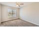 Bright bedroom with neutral walls and carpet plus a window and ceiling fan at 7838 W Layton Way, Littleton, CO 80123