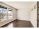 Bright bedroom with large window and hardwood floors, offering a cozy and inviting space at 7838 W Layton Way, Littleton, CO 80123