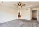 A well-lit bedroom with carpet flooring features a ceiling fan and access to the attached bathroom at 7838 W Layton Way, Littleton, CO 80123