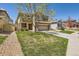 Beautiful home with a lush green lawn, a two-car garage, and a welcoming front porch at 7838 W Layton Way, Littleton, CO 80123