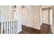 Hallway with arched doorways and hardwood floors, creating an elegant transition between rooms at 7838 W Layton Way, Littleton, CO 80123