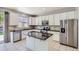 Well-lit kitchen with stainless steel appliances, granite counters, and ample cabinet space at 7838 W Layton Way, Littleton, CO 80123