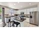 Bright kitchen featuring white cabinets, granite countertops and stainless steel appliances at 7838 W Layton Way, Littleton, CO 80123