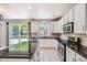 Bright kitchen featuring stainless steel appliances, granite countertops, and a sliding glass door to the backyard at 7838 W Layton Way, Littleton, CO 80123