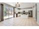 Bright kitchen featuring an island, stainless steel appliances, granite countertops, and a sliding glass door to backyard at 7838 W Layton Way, Littleton, CO 80123