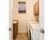 Functional laundry room with cabinets, tile floor, and a convenient window at 7838 W Layton Way, Littleton, CO 80123