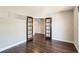 Spacious living room featuring hardwood floors and elegant glass panel doors at 7838 W Layton Way, Littleton, CO 80123