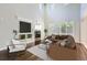Bright living room featuring a fireplace, hardwood floors, and a vaulted ceiling with lots of natural light at 7838 W Layton Way, Littleton, CO 80123