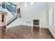 Spacious living room featuring hardwood floors, a cozy fireplace, and abundant natural light at 7838 W Layton Way, Littleton, CO 80123