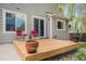 Cozy wooden deck offers outdoor seating with red chairs and a sliding door to the home's interior at 15901 E 106Th Way, Commerce City, CO 80022