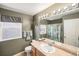 Full bathroom featuring a shower, single sink, mirror, and window providing ample lighting at 15901 E 106Th Way, Commerce City, CO 80022