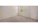 Carpeted bedroom with a window offering natural light and an electrical outlet at 15901 E 106Th Way, Commerce City, CO 80022