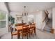 Formal dining room boasts a large bay window, chandelier, and convenient access to the kitchen and living areas at 15901 E 106Th Way, Commerce City, CO 80022